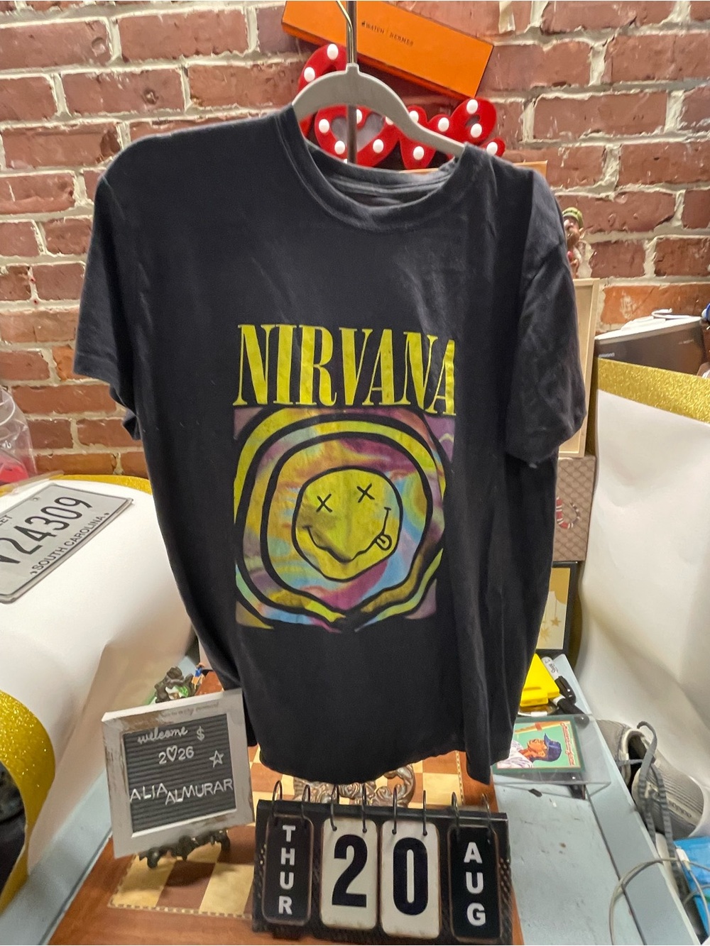 Nirvana band t-shirt features the iconic yellow "NIRVANA" block